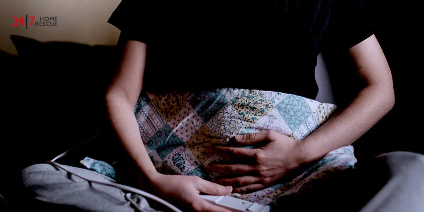 a girl holding an electrical blanket on her stomach