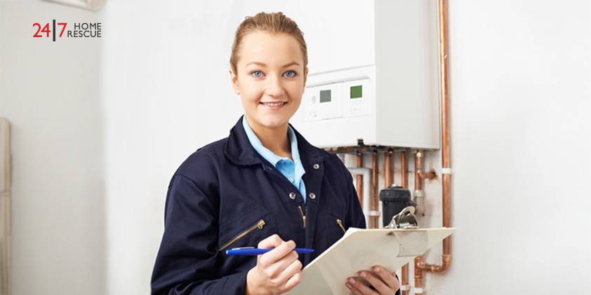 Female engineer documenting maintenance notes during boiler service inspection