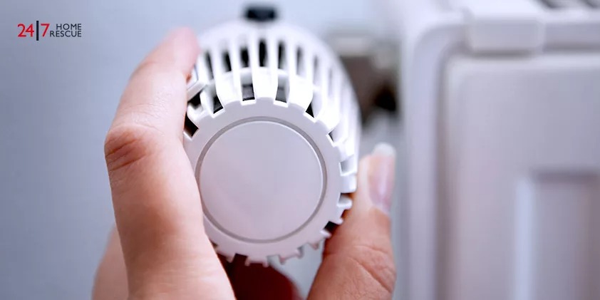Woman Hand Adjusting The Temperature By Thermostat
