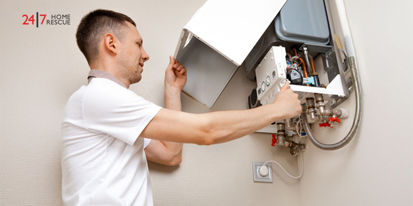 Engineer repairing a residential gas boiler heating system