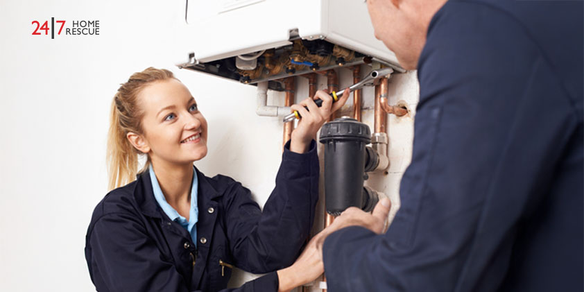 Person learning about boiler service tips with female engineer