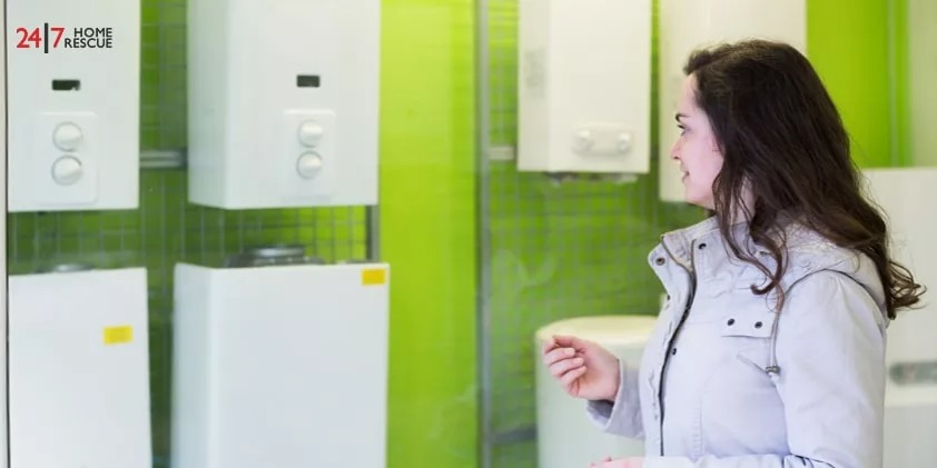 Person standing in front of a row of boilers