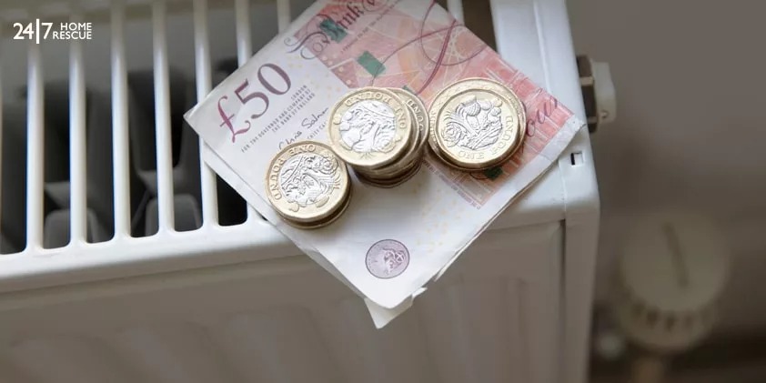 £50 note and coins on a radiator
