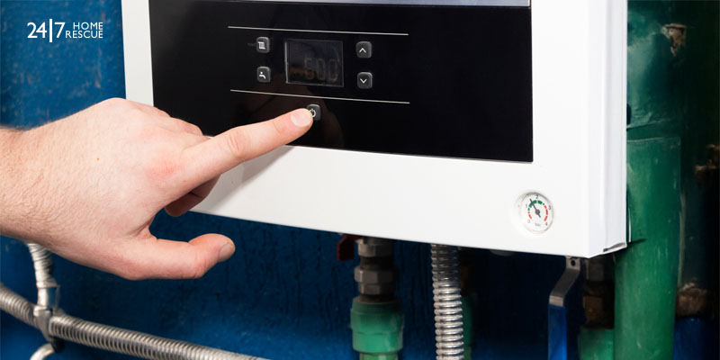 a finger pointing at a button on a machine