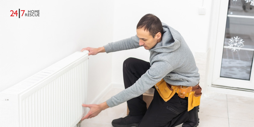 A heating engineer adjusting a radiator to ensure the home’s heating system is working efficiently
