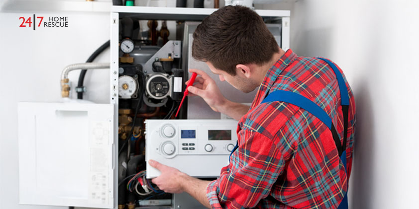 Technician servicing a gas boiler for home heating and hot water