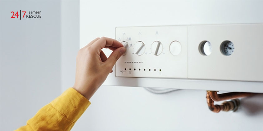 Young woman checking settings and temperature on the boiler at home