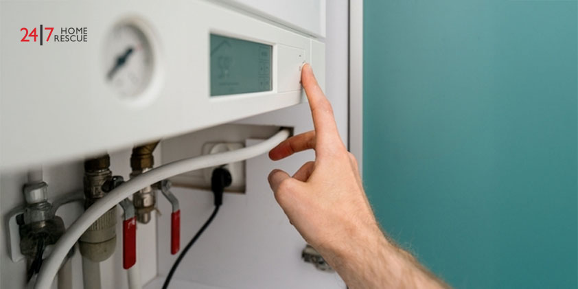 Person presses a button on a gas boiler control panel