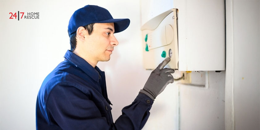 Smiling engineer repairing an gas boiler
