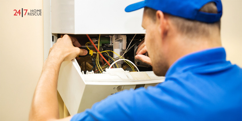 engineer solving wiring issues on a gas heating boiler 