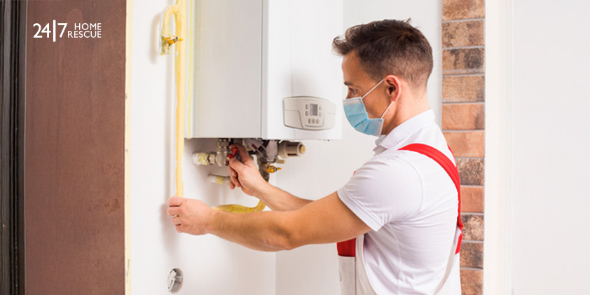 Engineer repairs a boiler in a medical mask 