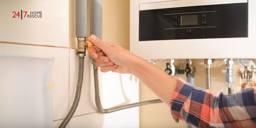 Woman turning on boiler gas valve