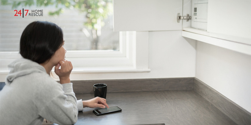 Woman checks combi boiler via phone because of early thermistor failure warning