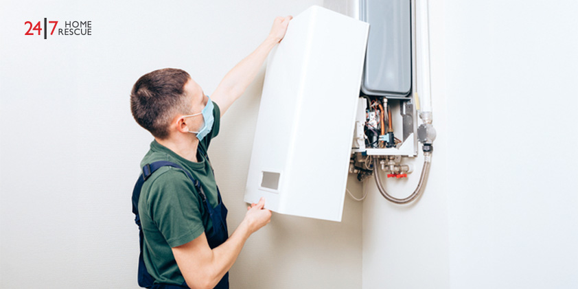 Engineer working to repair a gas boiler in a residential heating system