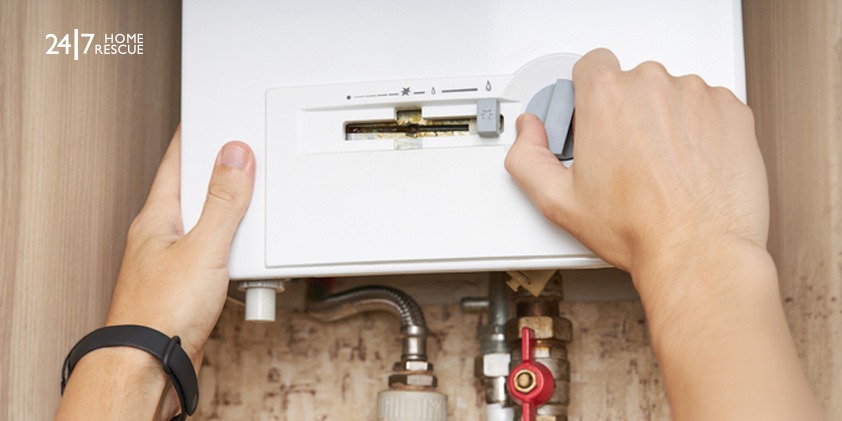 A person performing a DIY fix on a gas boiler
