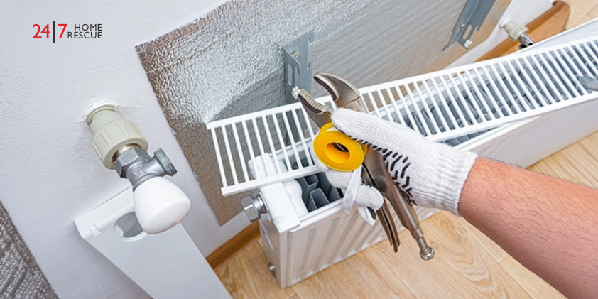 An engineer repairing a gas boiler’s radiator 