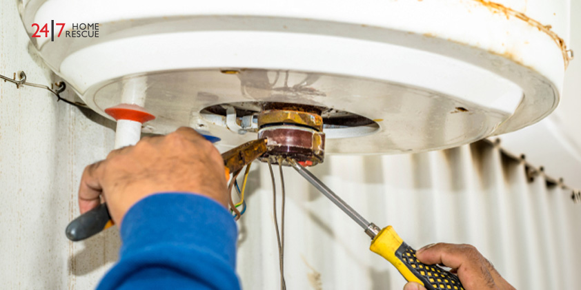 An engineer performing repairs on a gas boiler’s wiring 
