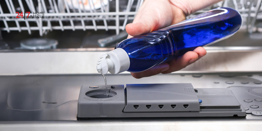 A man pouring cleaning supplies in a dishwasher’s compartment