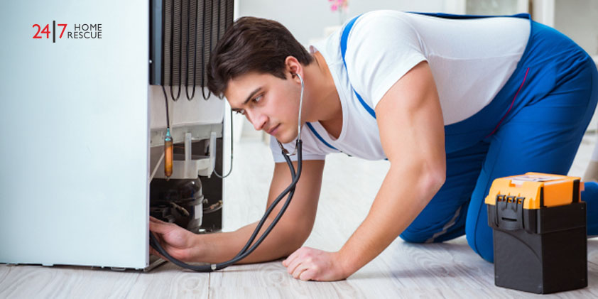 A repairman checking a fridge freezer for unusual noises