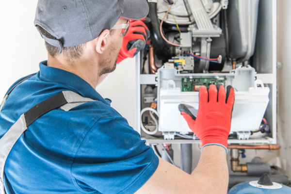 Boiler engineer carrying out maintenance on a home heating system
