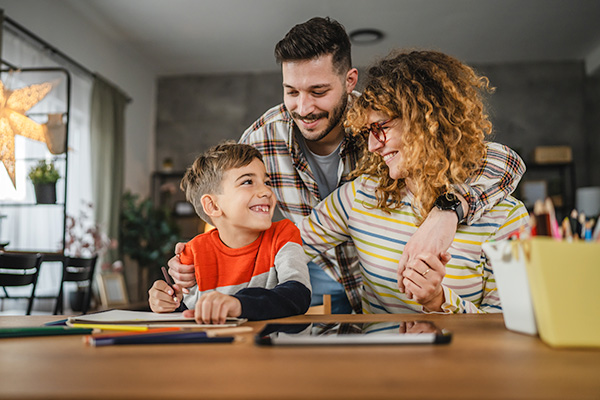 Parents and son at home table